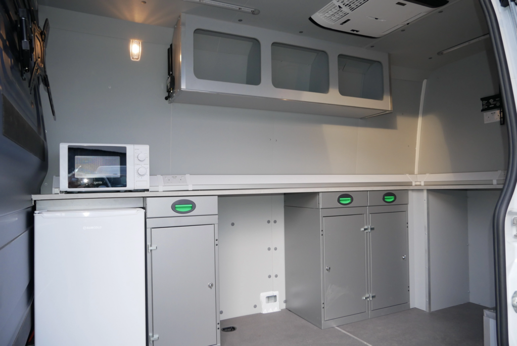 bespoke van conversion by SM UK with fridge, microwave, worktop space and air conditioning