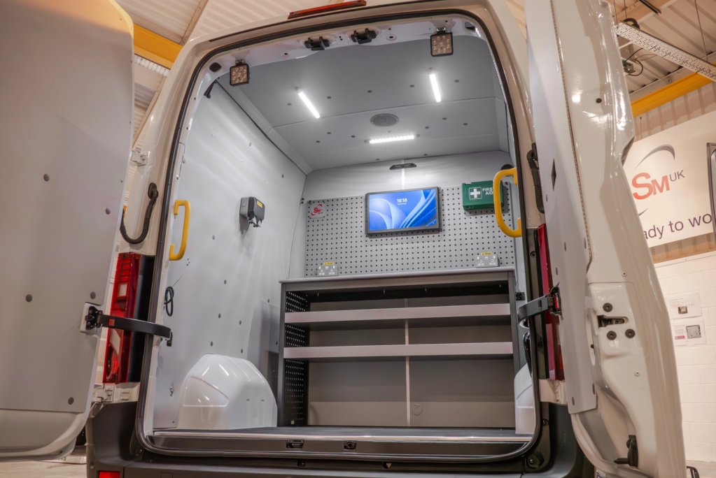 Drainage blueprint conversion showing the rear of a van with pc screen and desk
