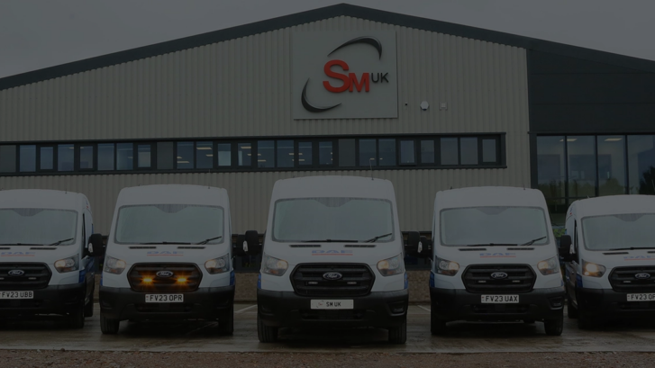 7 Ford Transit van conversions parked in front of SM UK head quarters