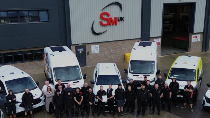 Various Ford vehicles and staff from SM UK celebrating achieving Ford Pro Converter accreditation